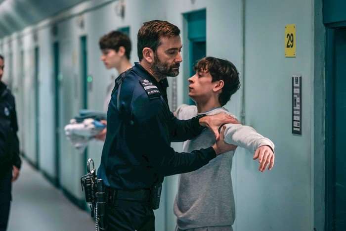 571857,TITLE:TIME - Series 3 David Tennant and Louis McCartney star in Time season 3; in this scene, Custodial Manager Bailey is patting down James outside of his prison cell