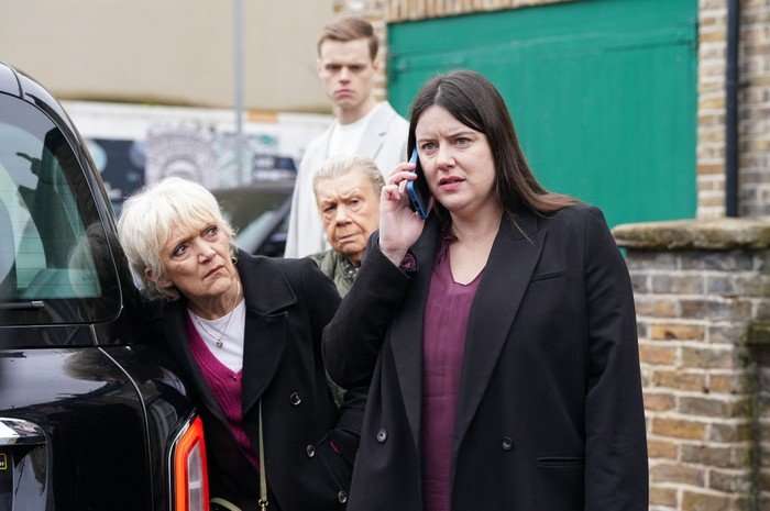 556052,TITLE:Eastenders Jean, Oscar and Mo crowd around Zoe in a scene from EastEnders
