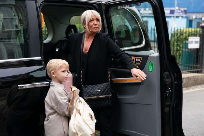 Sharon and Albie step out of a cab in EastEnders