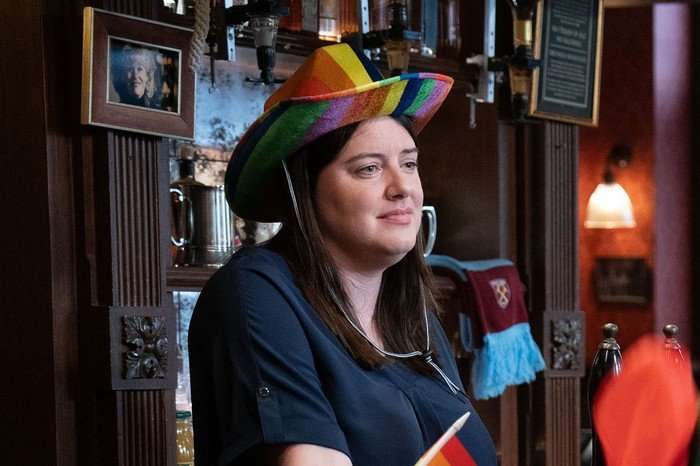 Zoe Slater wearing a multi-coloured cowboy hat for Walford Pride in a scene from EastEnders