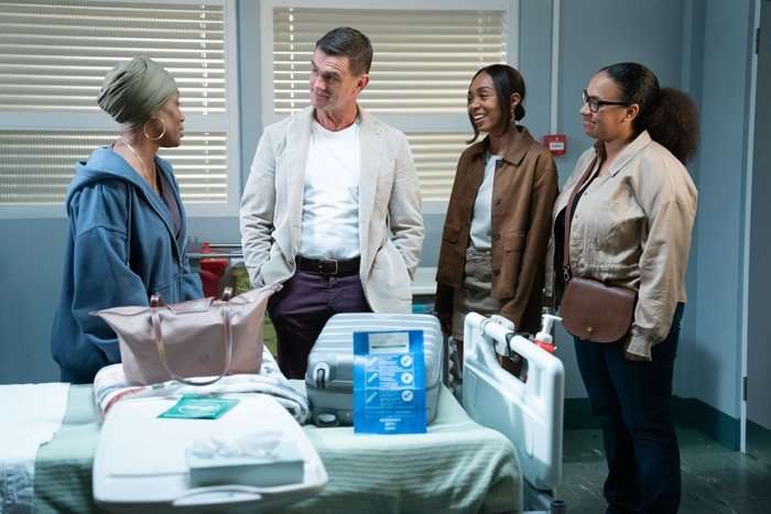566646,TITLE:Eastenders Libby, Jack and Chelsea look towards Denise in hospital in a scene from EastEnders