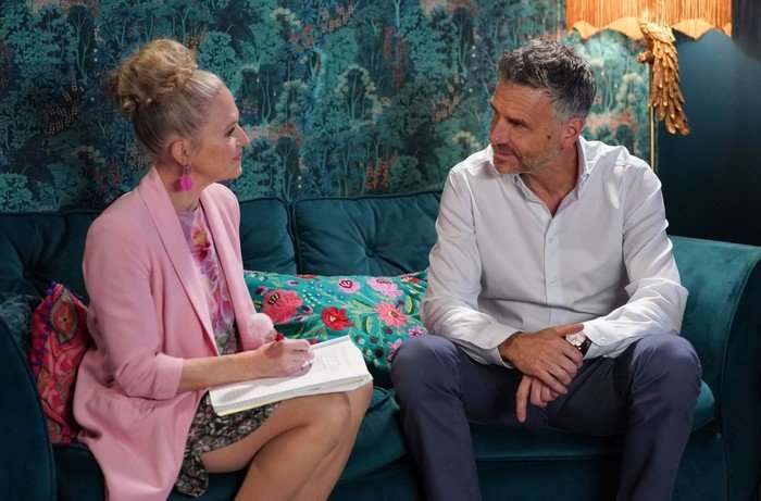 566718,TITLE:Eastenders Linda chats to Clive on the sofa in a scene from EastEnders