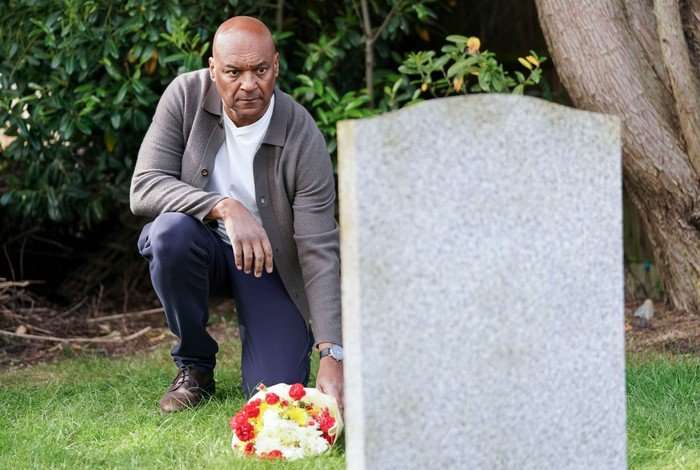 568605,TITLE:Eastenders George places flowers on Gloria's grave in a scene from EastEnders