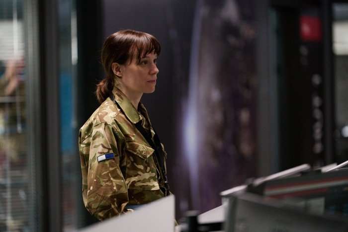 The Undeclared War - Series 2 Ep1 Chloe Pirrie as Lt Col Roz Cavendish in The Undeclared War, wearing an army uniform and stood in an office.