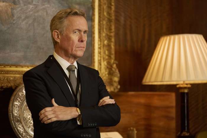 The Undeclared War - Series 2 Ep2 Alex Jennings as David Neal in The Undeclared War, wearing a suit and with his arms crossed.