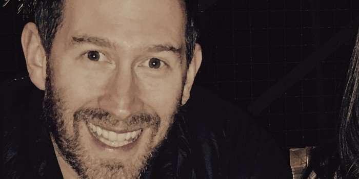 A close up of a man smiling for a photo.