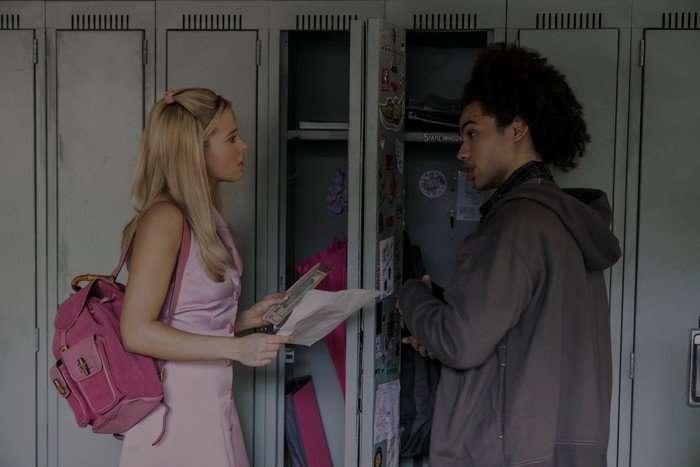 Lexi Minetree as Elle and Zac Looker as Dustin in Elle, stood by a set of lockers.