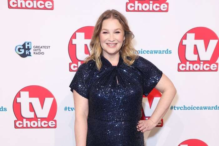 TV Choice Awards 2024 VIP Arrivals Joanna Page wearing a sparkly blue dress, smiling ahead and posing with one hand on her hip.
