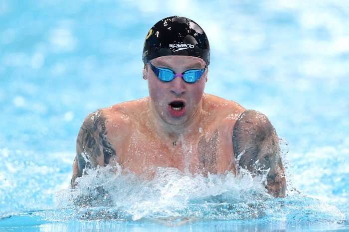 Commonwealth Games 2026 highlights Swimmer Adam Peaty, in a black swim cap and goggles, swimming in a pool.