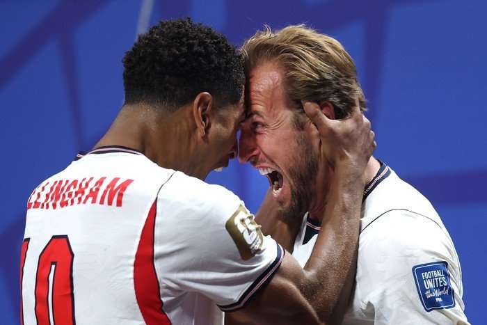 World Cup 2026 next round England players Harry Kane and Jude Bellingham, in white football kit, shout in celebration with their heads pressed against eachother at World Cup 2026.