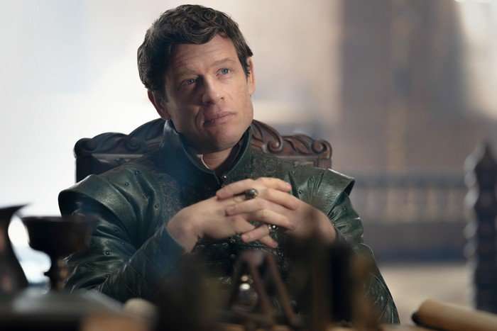 James Norton as Lord Ormund Hightower in House of the Dragon season 3, sitting at a table with his hands crossed