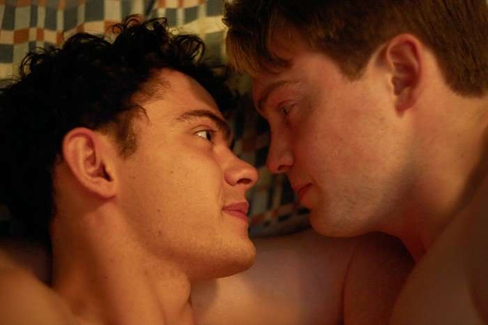 Charlie and Nick lie in bed together, staring closely into each other's eyes