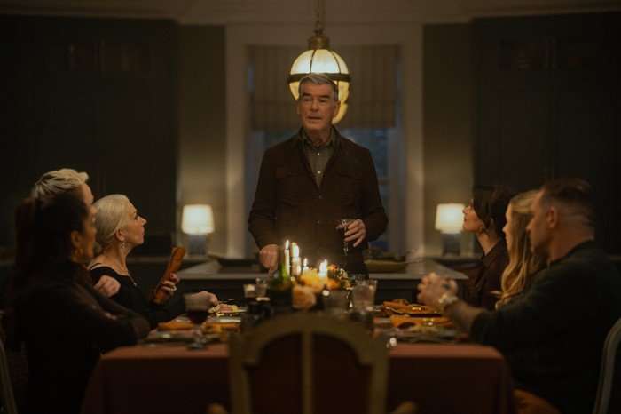 Beggars Banquet Mandeep Dhillon as Seraphina Harrigan, Anson Boon as Eddie Harrigan, Helen Mirren as Maeve Harrigan, Pierce Brosnan as Conrad Harrigan, Emily Barber as Alice, Joanne Froggatt as Jan Da Souza and Tom Hardy as Harry Da Souza in MobLand. Conrad is stood at the head of a dining table and the others are sat down around the table