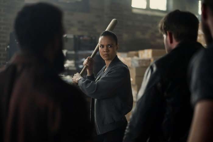 Neagley Neagley wields a baseball bat defensively against approaching men in a dingy warehouse setting