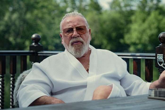 Ray Winstone as Bobby Glass in The Gentleman season 2. Bobby Glass wearing a robe.