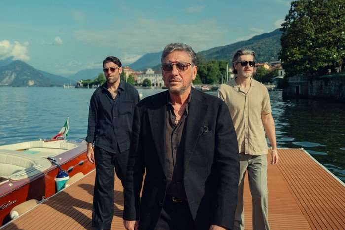 Sergio Castellitto as Marco Moretti in The Gentleman season 2. Marco Moretti walking along a pier.