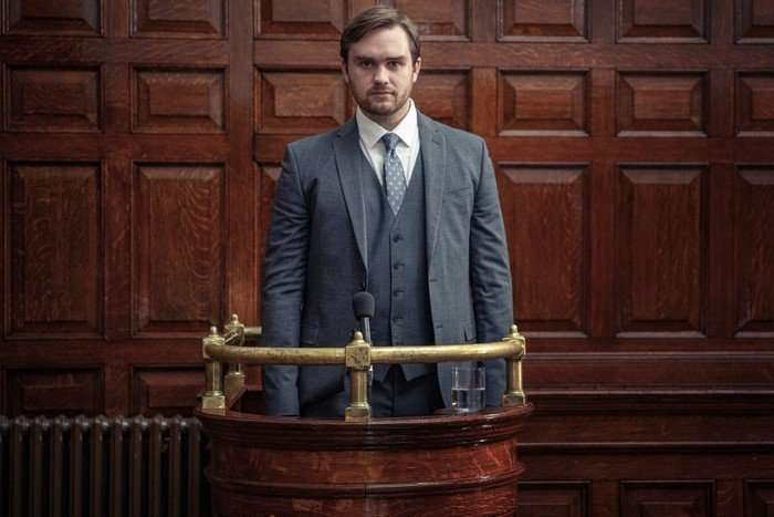 emmerdale-tom-court-dock Tom King dressed in suit and tie as he stands trial in Emmerdale