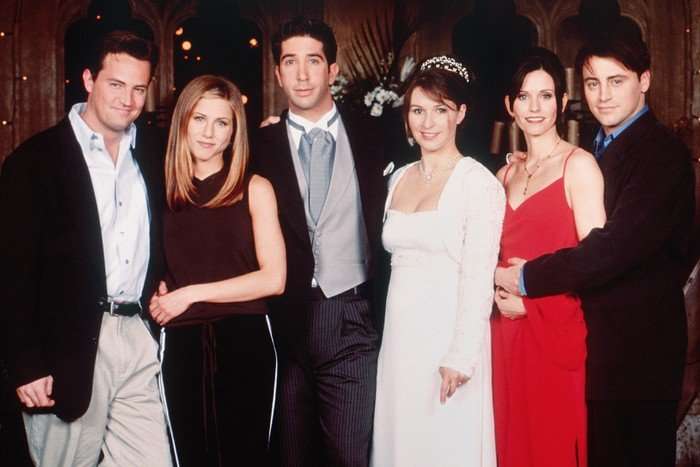 Friends cast standing together looking into camera