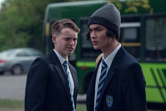 Harry sneers at a frustrated Tao outside the school gates