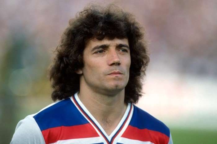UEFA Euro 1980 Italy-England Kevin Keegan wearing a blue, red and white football shirt, pictured from the chest up on the pitch with a serious expression.