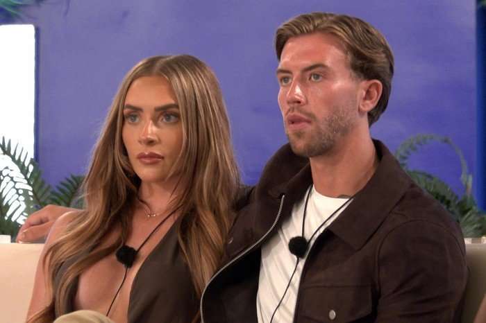 Love Island S13 Elicia and Aidan sat down next to each other looking seriously ahead.