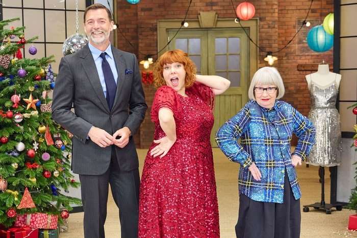 Patrick Grant, Sophie Whelan and Esme Young stood in a row smiling and posing ahead.