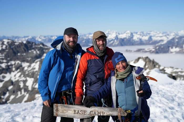 Drew, Dockers and Colleen at the base camp point, smiling ahead at the top of the mountain.